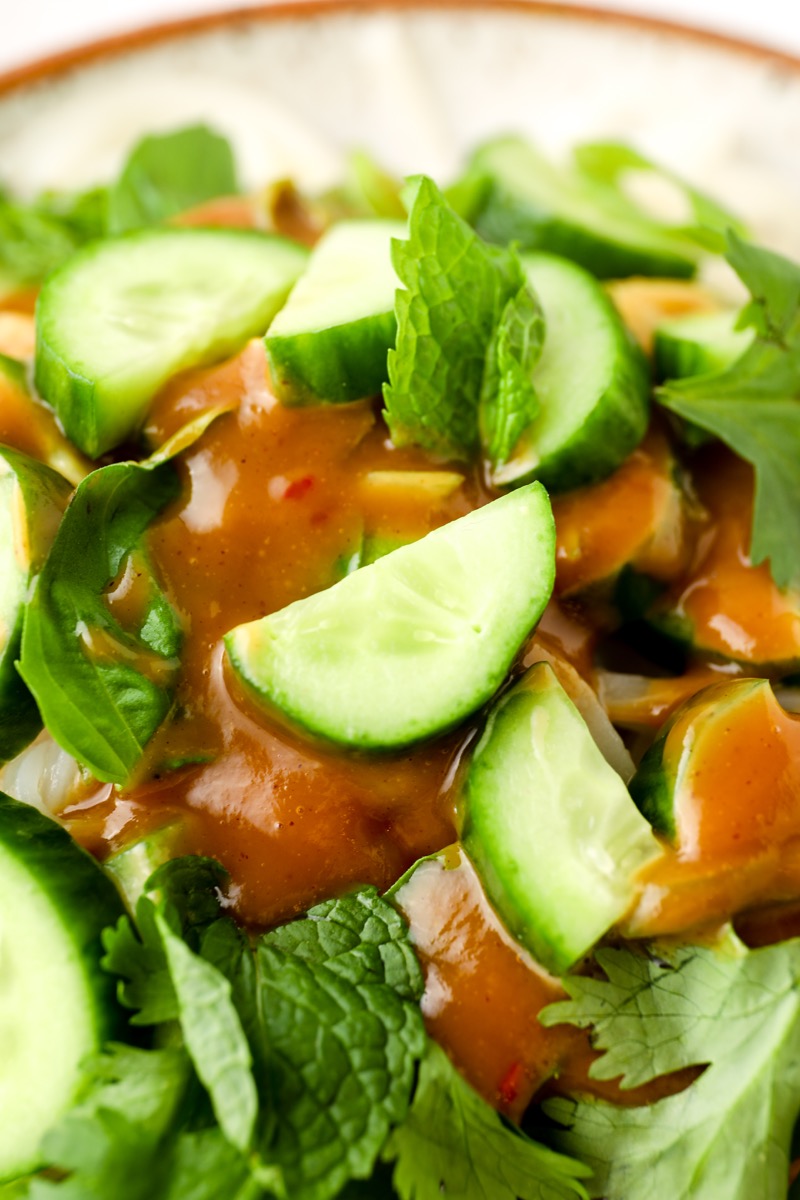 close up view of sliced mini cucumber in vegan summer roll in a bowl