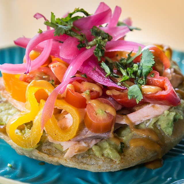 Mixed vegetables, with avacado spread on a bun.