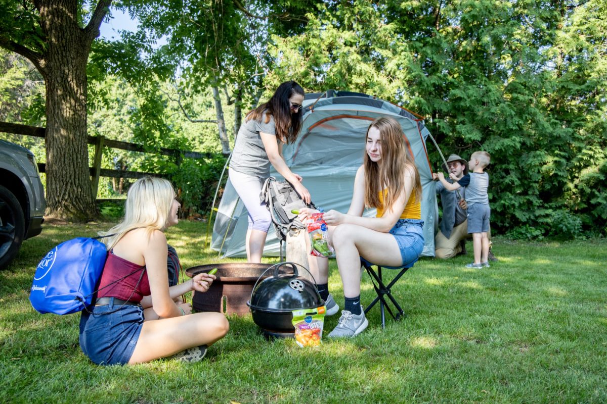 Girls eating veggies in camping spot