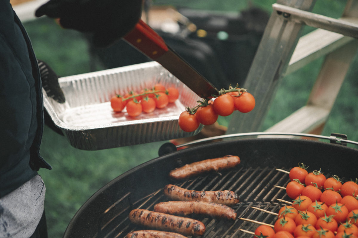 Grilling tomatoes on the vine and sausages