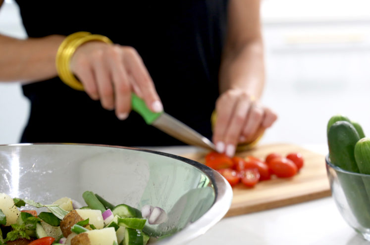 woman chopping grape tomatoes