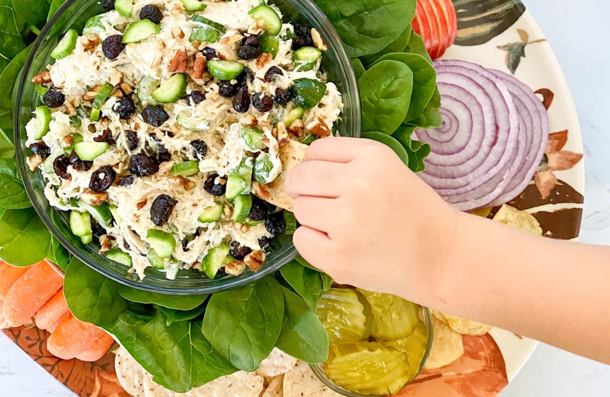 hand dipping cucumber turkey salad