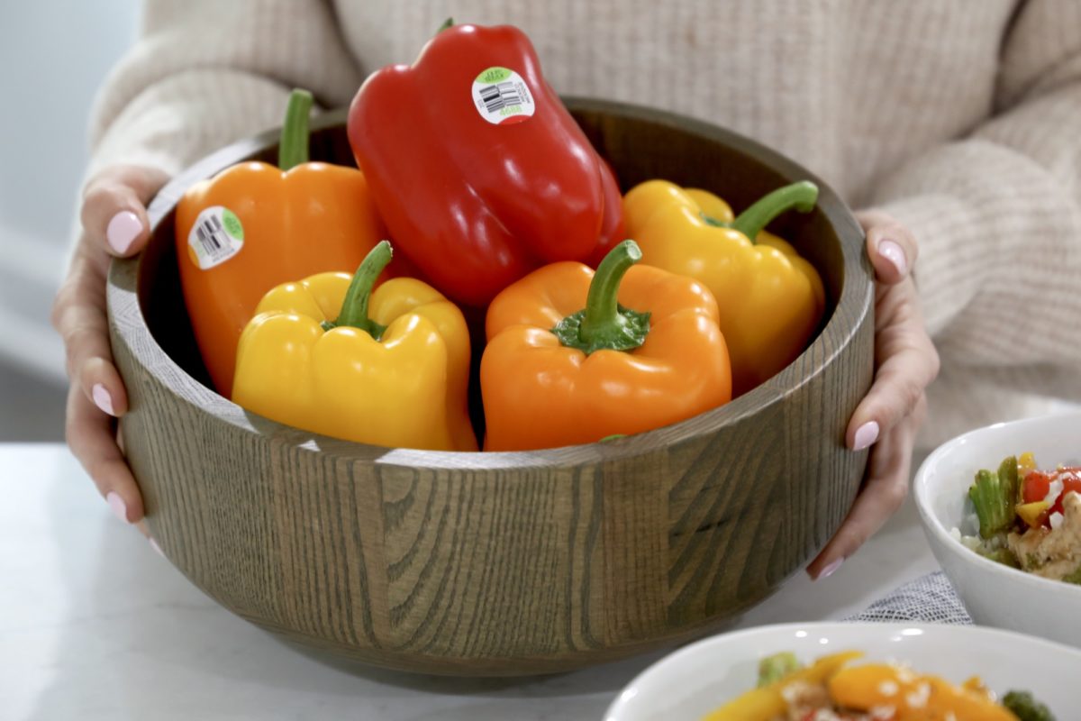 woman holding bowl of sweet bell peppers