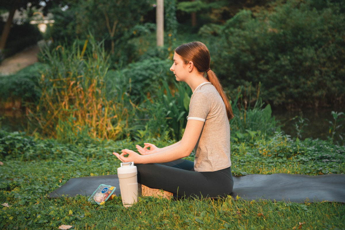 Girl meditating in the park