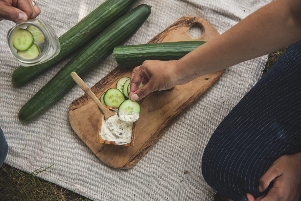Organic cucumbers in cutting board