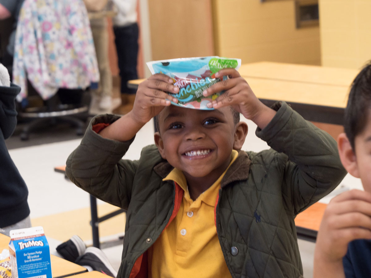 Child holding up a pack of Mini Munchies®