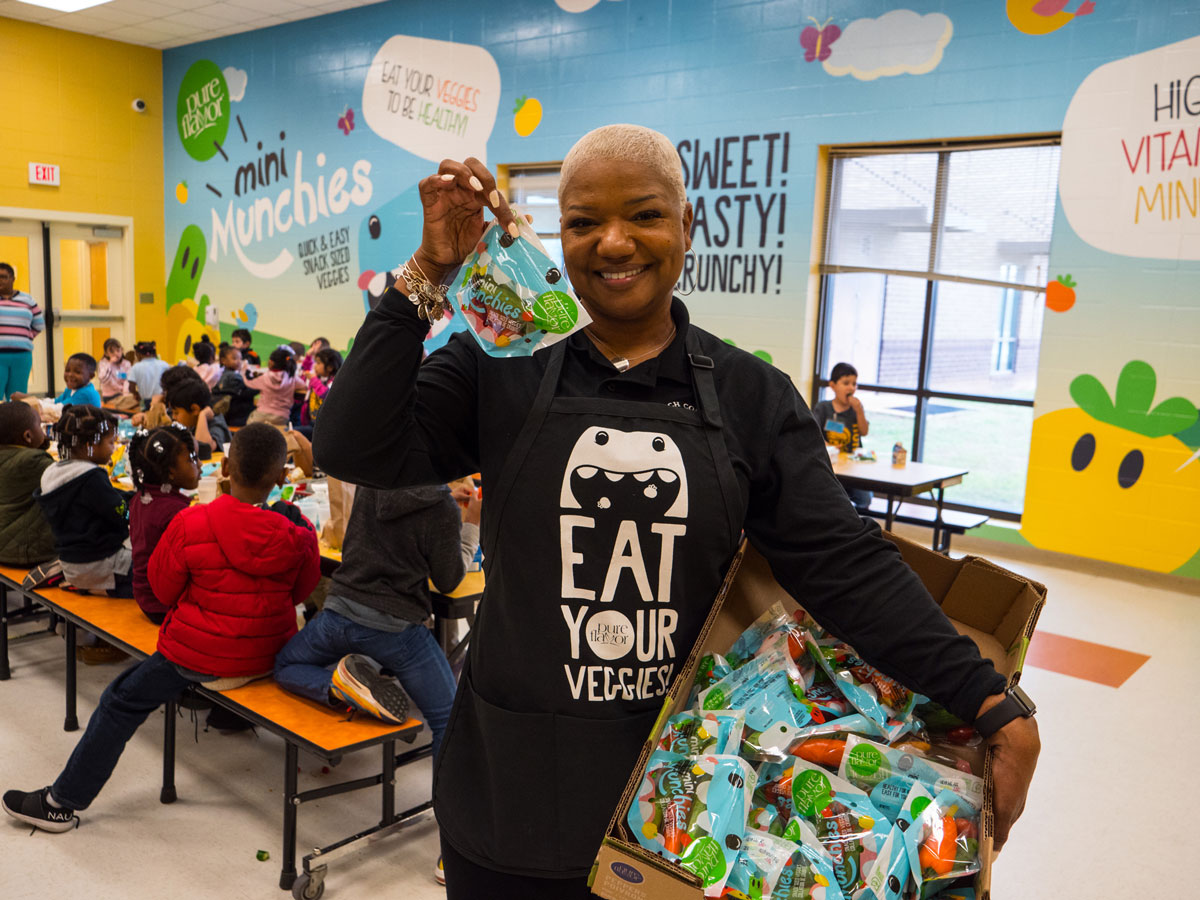 Women holding up a pack of Mini Munchies®