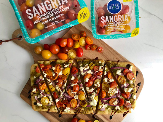 board with packs of sangria medley tomatoes and flatbread