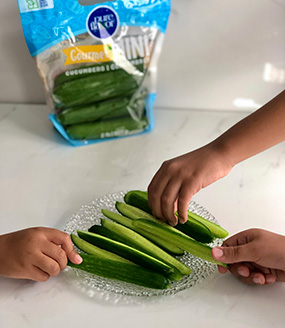 Kids Sharing Mini Cucumbers