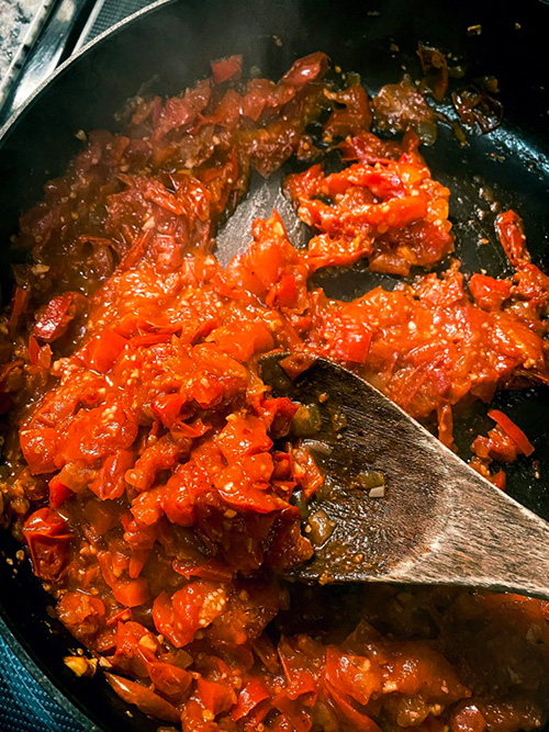 mixing tomato chutney in a pan