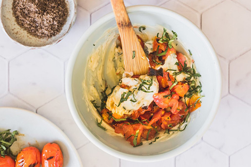 mixing ingredients for homemade tomato basil butter