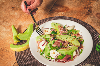 Person eating Solara™ Melon Salad