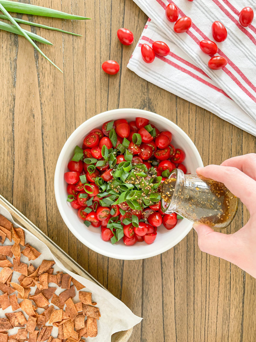 Dressing tomato salad with oil