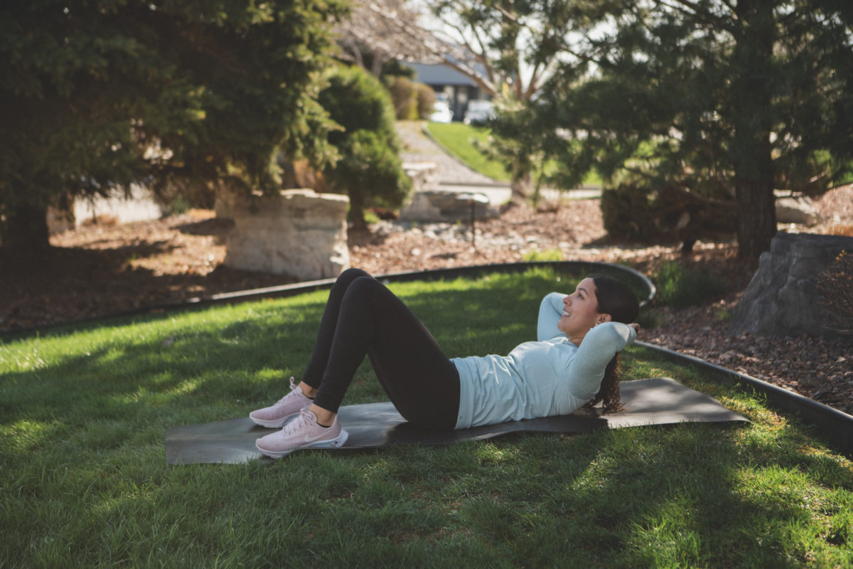 Woman doing crunches in a park