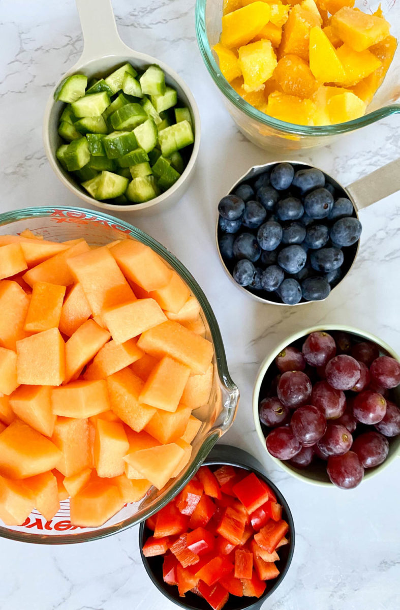 Veggies and fruit in cutting board