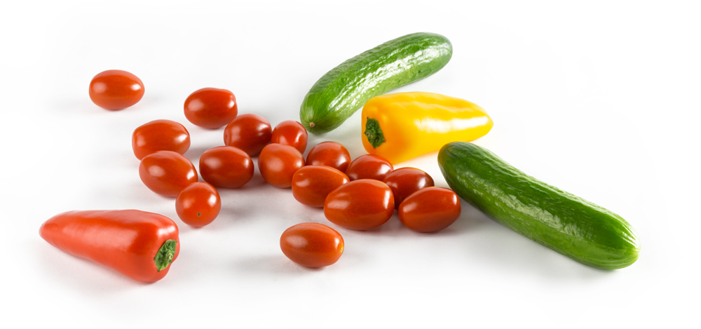 Red Grape Tomatoes, Mini Cucumbers, and Mini sweet peppers on a white background.