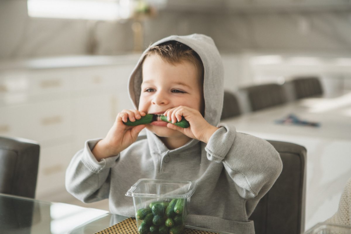 Kid enjoying uno bites in kitchen
