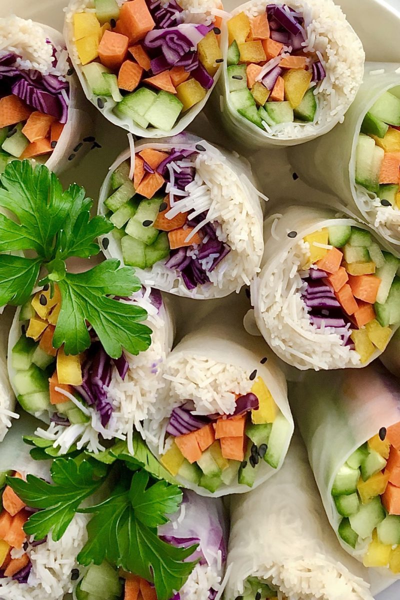Several colourful vegetarian rice wraps ready to eat