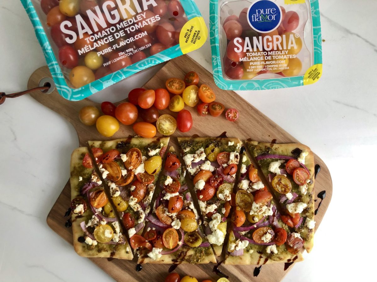 board with packs of sangria medley tomatoes and flatbread